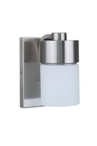 The District - 12305 is a modern wall-mounted light fixture featuring a cylindrical white opal glass shade and brushed metal finish. Part of the vanity collection, its mounted on a rectangular metal backplate, blending sleek design with contemporary elega