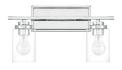 The Clark - 20417 fixture has a modern chrome finish, two clear glass shades, and a rectangular backplate. Damp-rated and minimalist, it complements a 4-light vanity for cohesive contemporary elegance.