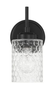 Part of the Claire - 60501 collection, this wall-mounted light fixture features a black metal base and clear bubble-textured cylindrical glass shade, elegantly diffusing light for a sophisticated touch.