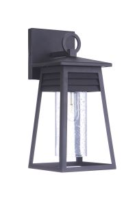 The Becca - ZA2704-TB is a black outdoor wall lantern featuring a rectangular frame and textured glass casing for the bulb. With a louvered detail, top ring, and flat roof-like cover, its coastal aesthetic makes it perfect for transforming your patio into