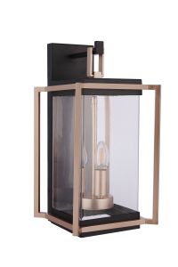 The Metalwork - ZA6514-MNSB by Craftmade is a modern outdoor wall lantern featuring a sleek rectangular design. It has a satin brass frame with clear glass panels and a candelabra-style bulb fixture, blending elegance and practicality.