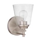 The Drake - 19606 is a wall-mounted light fixture featuring a brushed polished nickel finish and a clear seeded glass shade. Its visible bulb adds charm, while the modern and sleek design enhances any space.