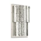 The Museo - 48662 is a wall-mounted sconce light featuring three panels of textured, curved silver metal. These layered panels create a tiered chandelier effect, reflecting light in multiple directions. It boasts a simple matte base and offers a modern de