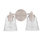 The Tyler - 50202 is a dual light wall fixture in polished nickel, featuring clear seeded glass shades that reveal visible bulbs, and it is mounted on a round base.