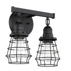 The Thatcher - 50602 is a black industrial-inspired wall fixture featuring two bulb sockets in black wire cages. It combines visible LED filament bulbs for vintage charm with a matte finish and circular base, accented by an angled arm for a modern classic