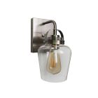 The Trystan - 53501 wall-mounted sconce features a brushed metal finish, clear glass shade, and exposed Edison bulb.