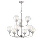 The Glenda - 56229 chandelier features nine clear glass globes with visible filament bulbs, a brushed nickel finish, and a metal frame with curved arms. Its elegantly suspended by a chain from a circular ceiling mount.