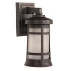 The wall-mounted Resilience Lanterns - ZA2304 features a frosted glass cylinder in a dark metal frame with a grid pattern, blending traditional and modern styles. Its rectangular backplate and cap are crafted from durable, non-corrosive, UV-resistant resi